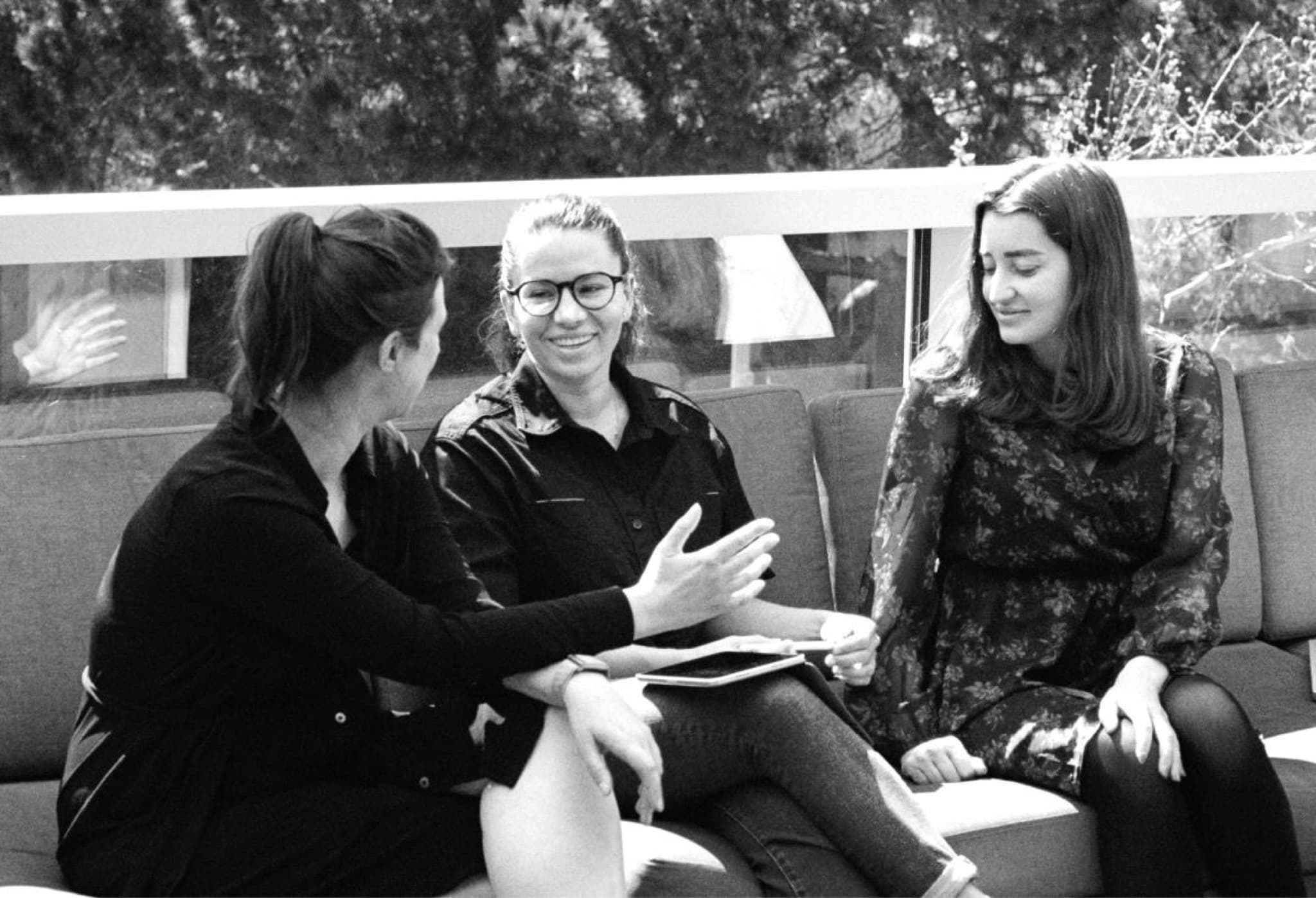 Women casually chatting on a sunny couch