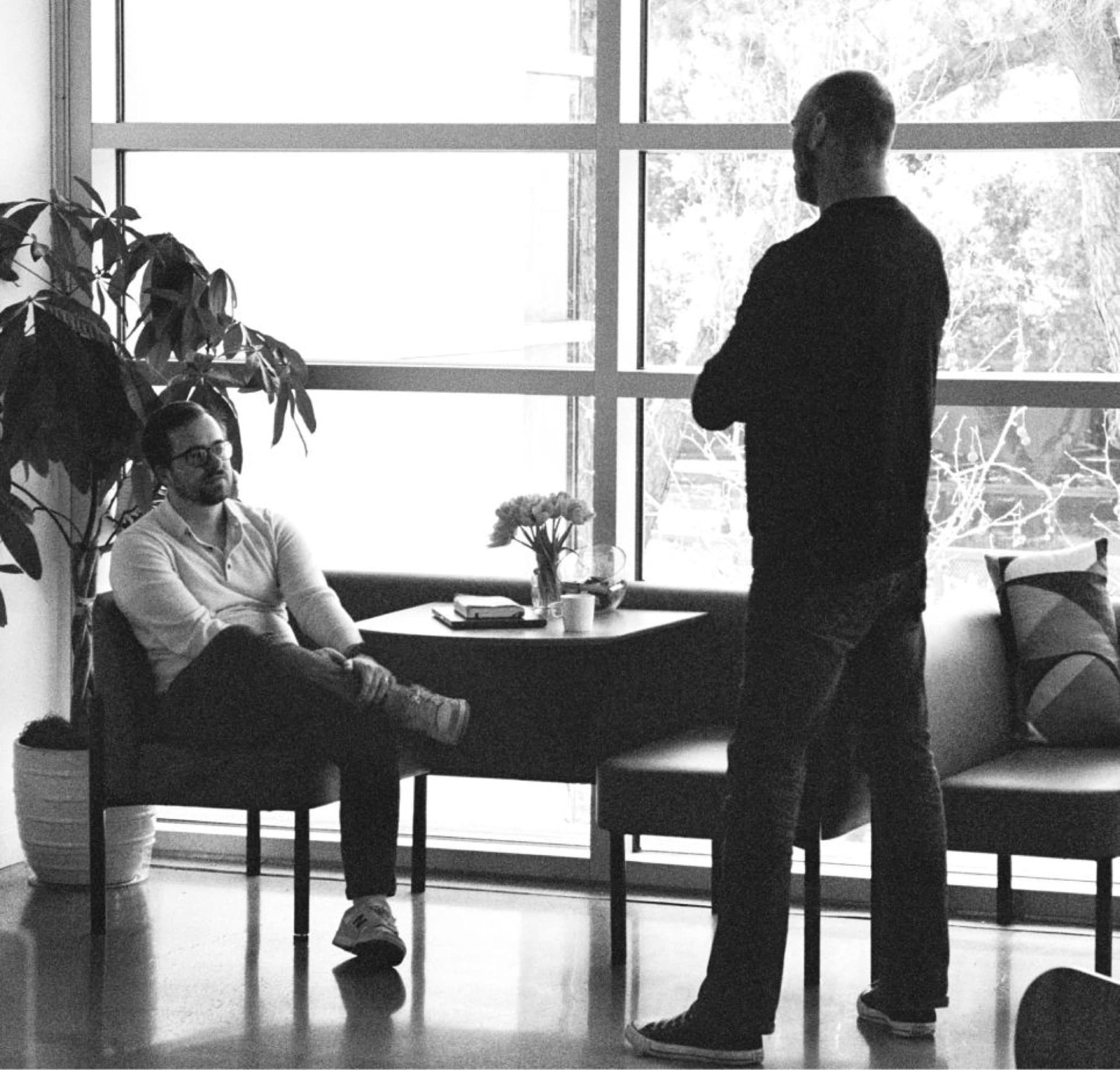 Two men having a coffee break chat