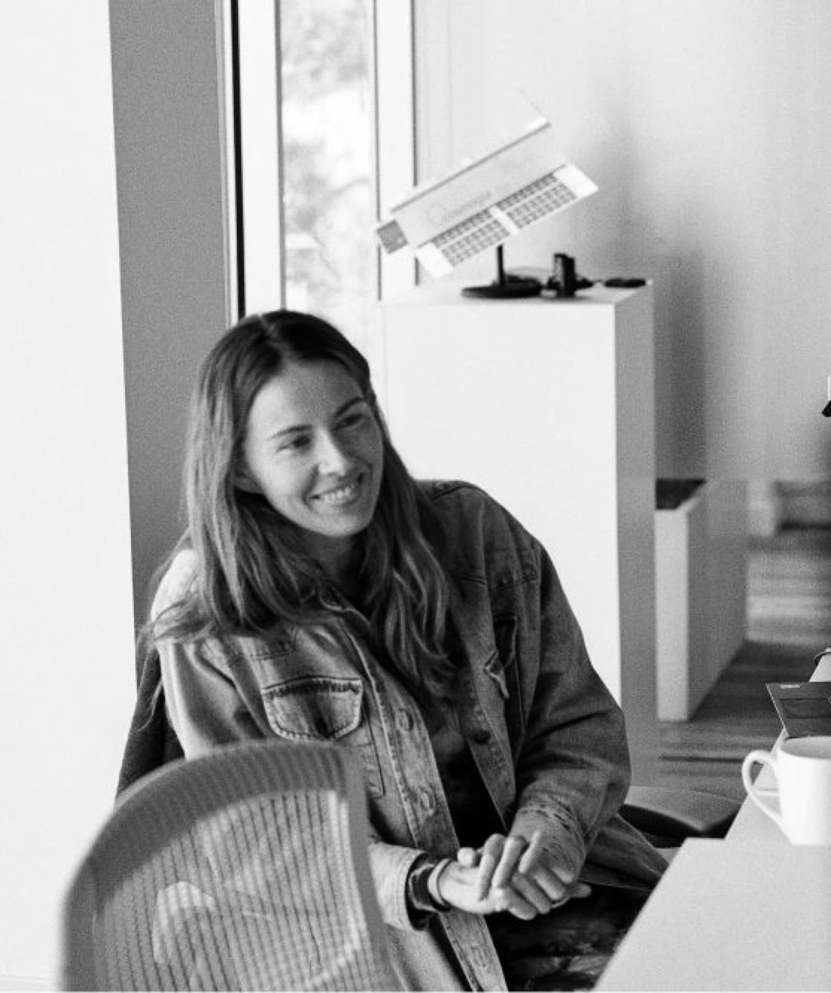 Someone looking up from their desk to talk with a team member